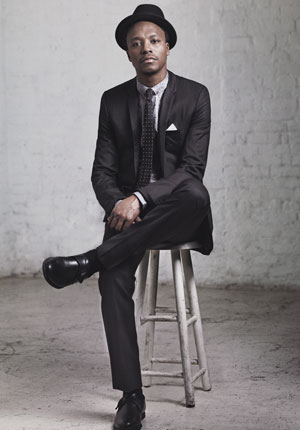 lupe_fiasco_on_stool_in_suit_varticle